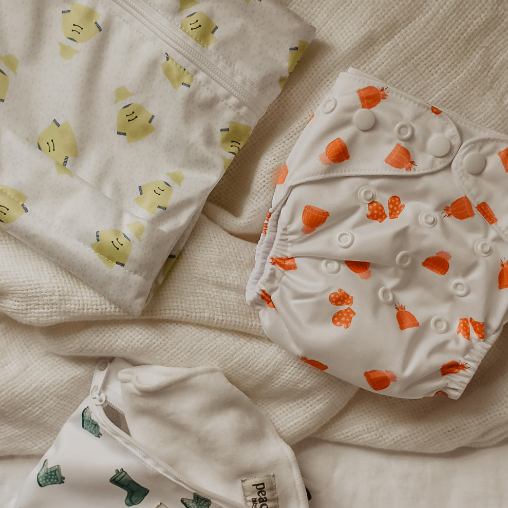 Mittens print modern cloth nappy and a wellies wet bag and raincoat wetbag by Peachi Baby 