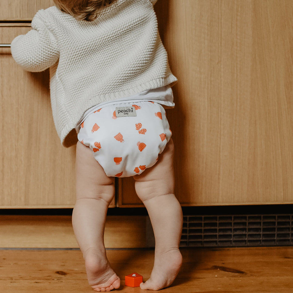 toddler standing wearing a mittens print modern cloth nappy