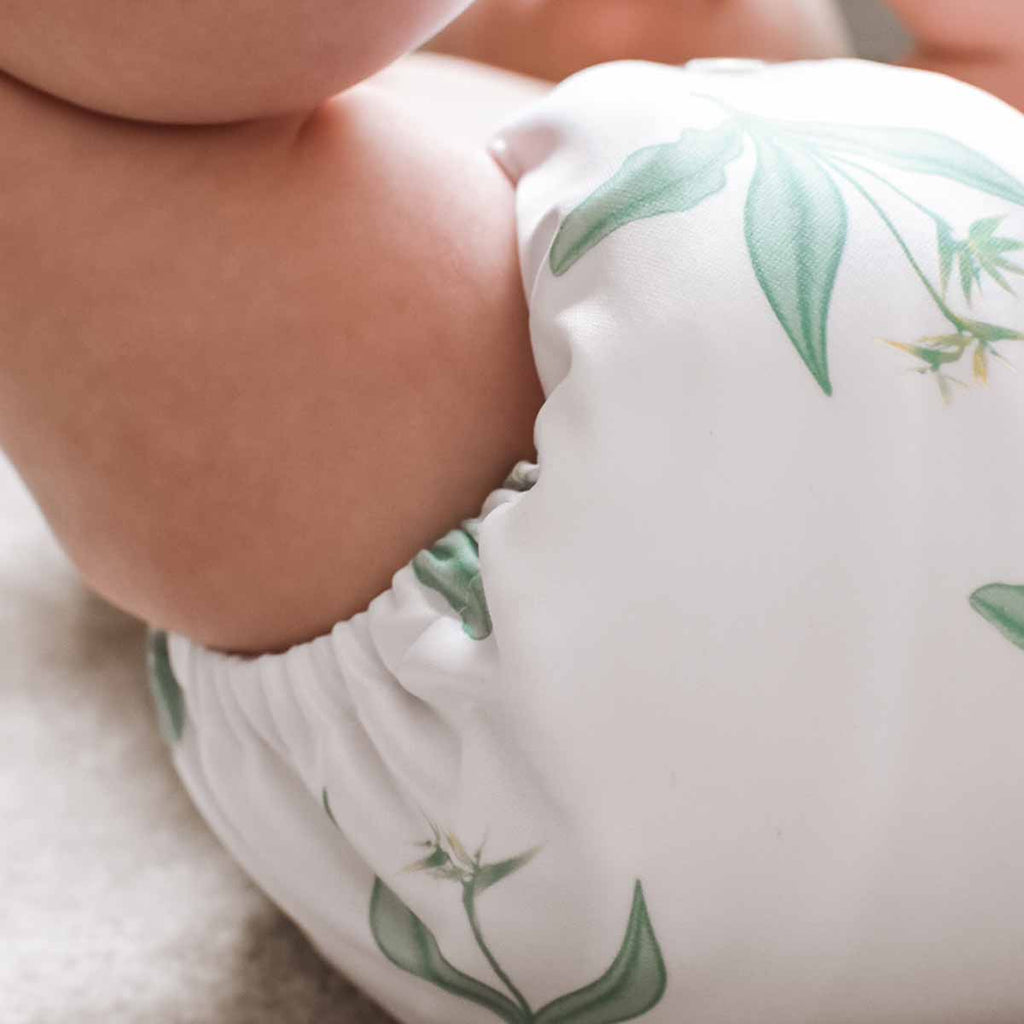 Baby wearing a Paradise Fern reusable nappy by peachi baby