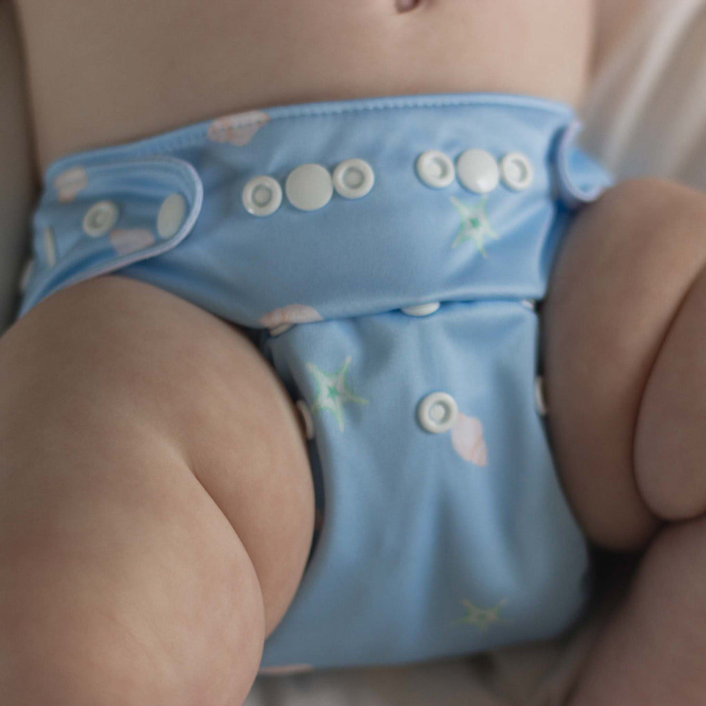 baby boy wearing a seashells reusable nappy