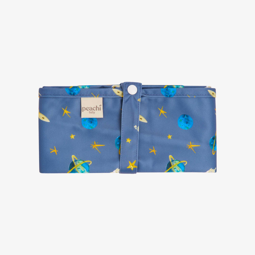a navy blue travel changing mat for babies and toddlers in a space pattern