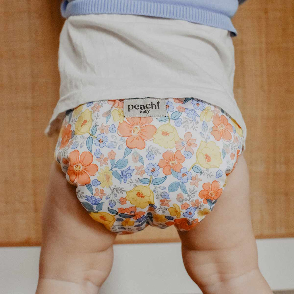baby wearing a ditsy floral reusable nappy