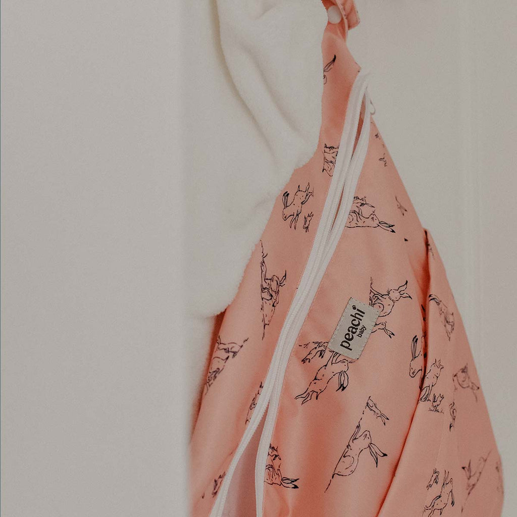hares print nappy wetbag in a peach print