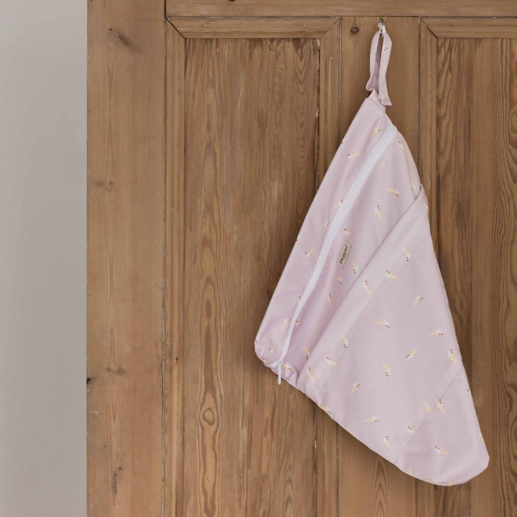 a wetbag for baby and toddler clothing in a lilac Ice Cream print
