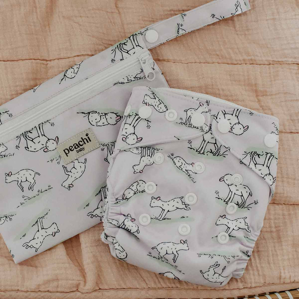 lilac lamb print reusable nappy and a matching mini wet bag