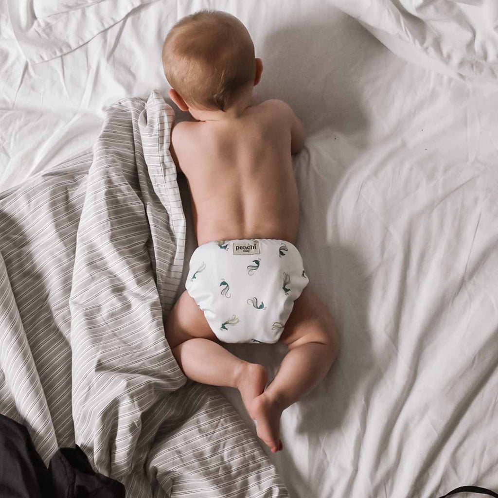 Toddler wearing a modern cloth nappy in a lyrebird print