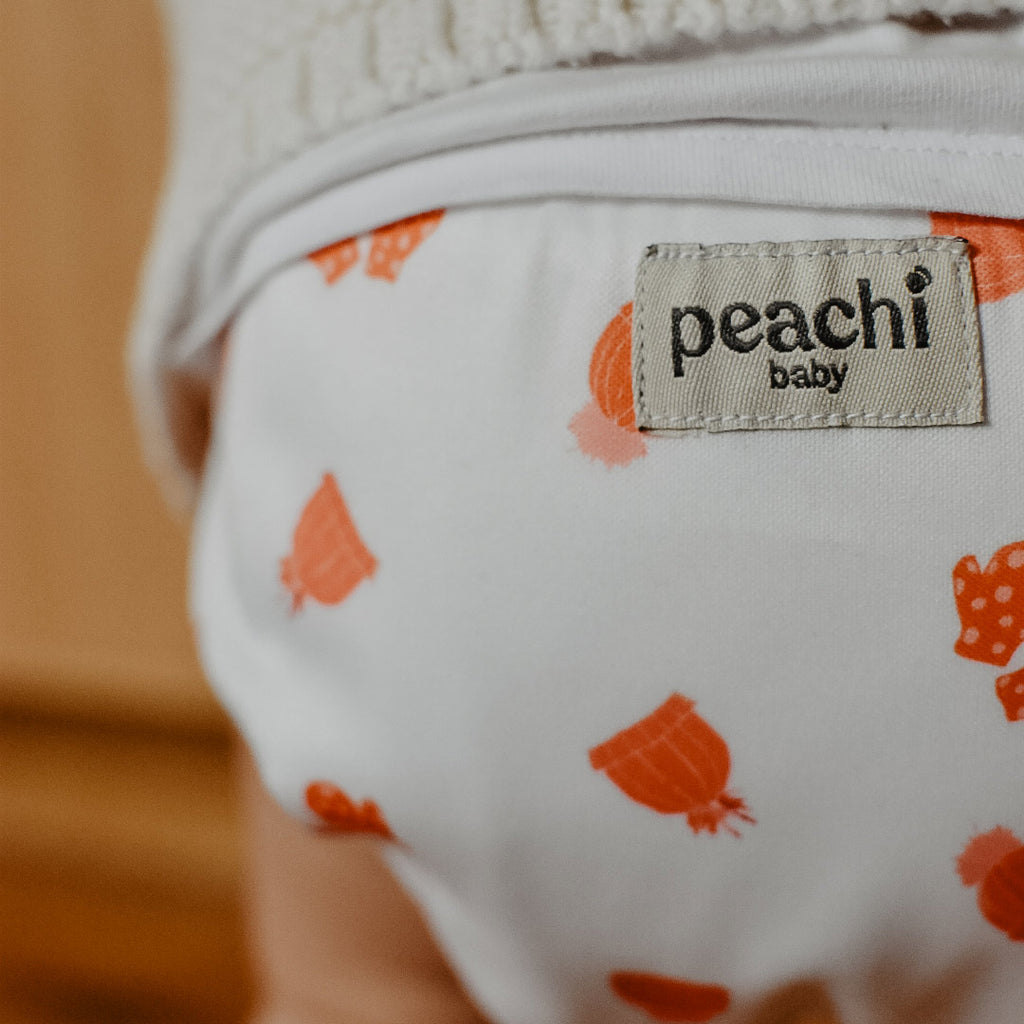 Toddler wearing a Mittens print modern cloth nappy by Peachi Baby