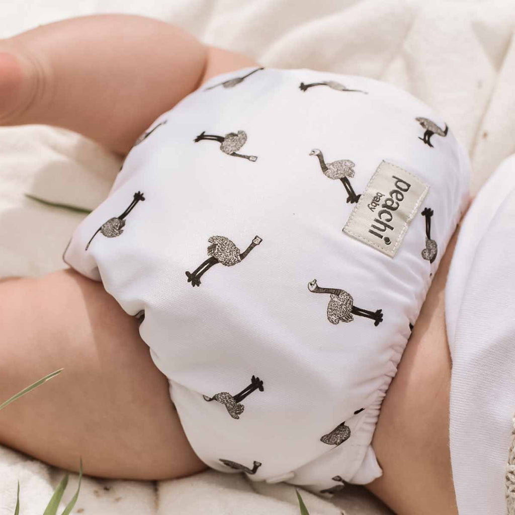 Baby wearing a Ostrich print modern cloth nappy by Peachi Baby