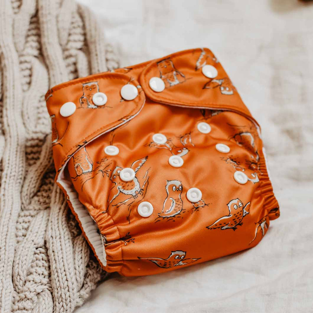 an orange owls print reusable modern cloth nappy by peachi baby