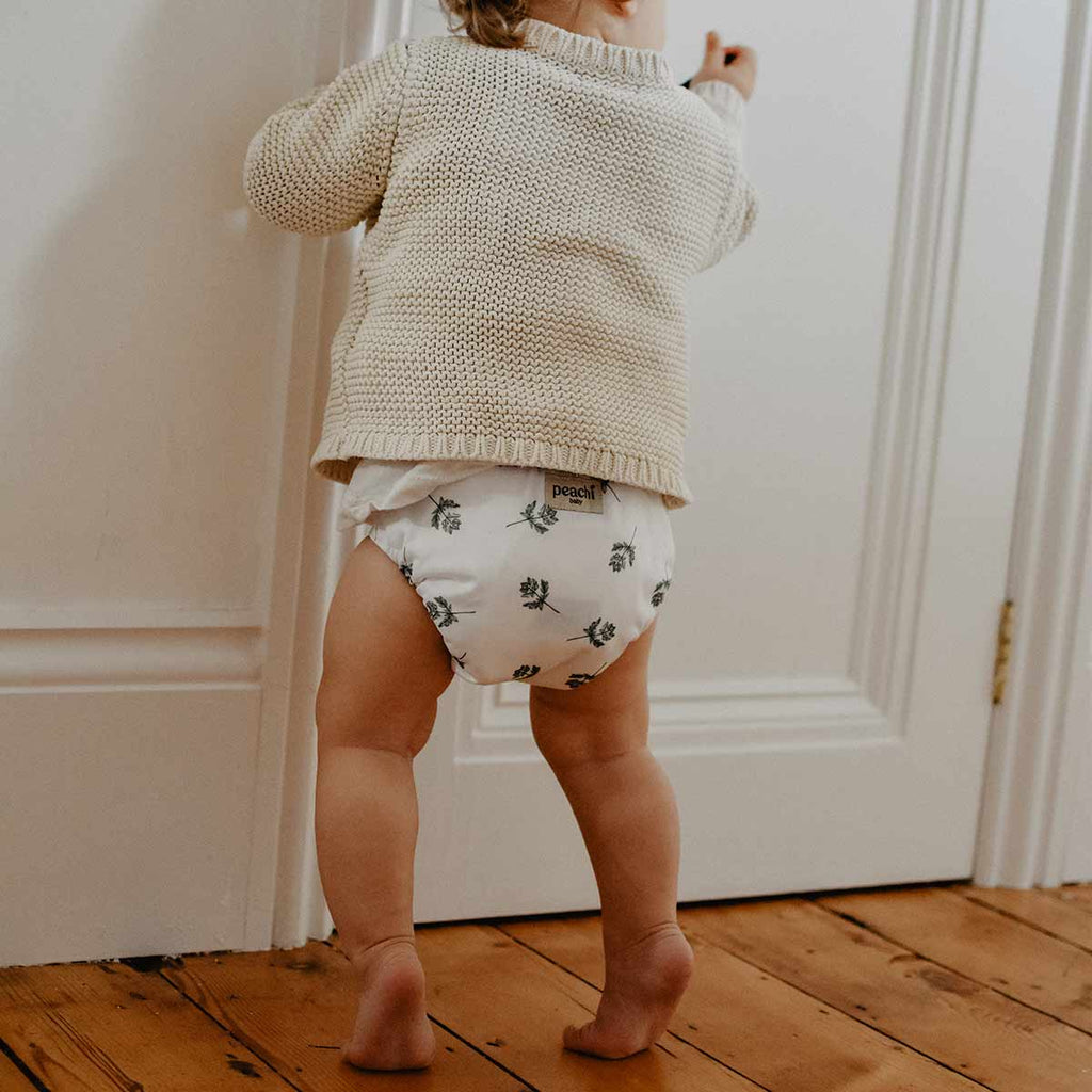 Toddler wearing a Parsley print modern cloth nappy by Peachi Baby