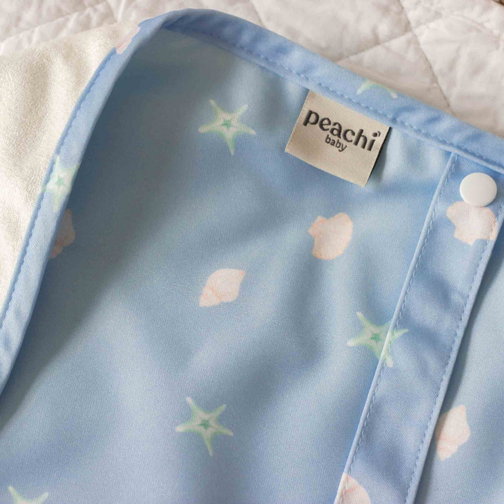 a baby blue, seashells print travel changing mat for babies and toddlers
